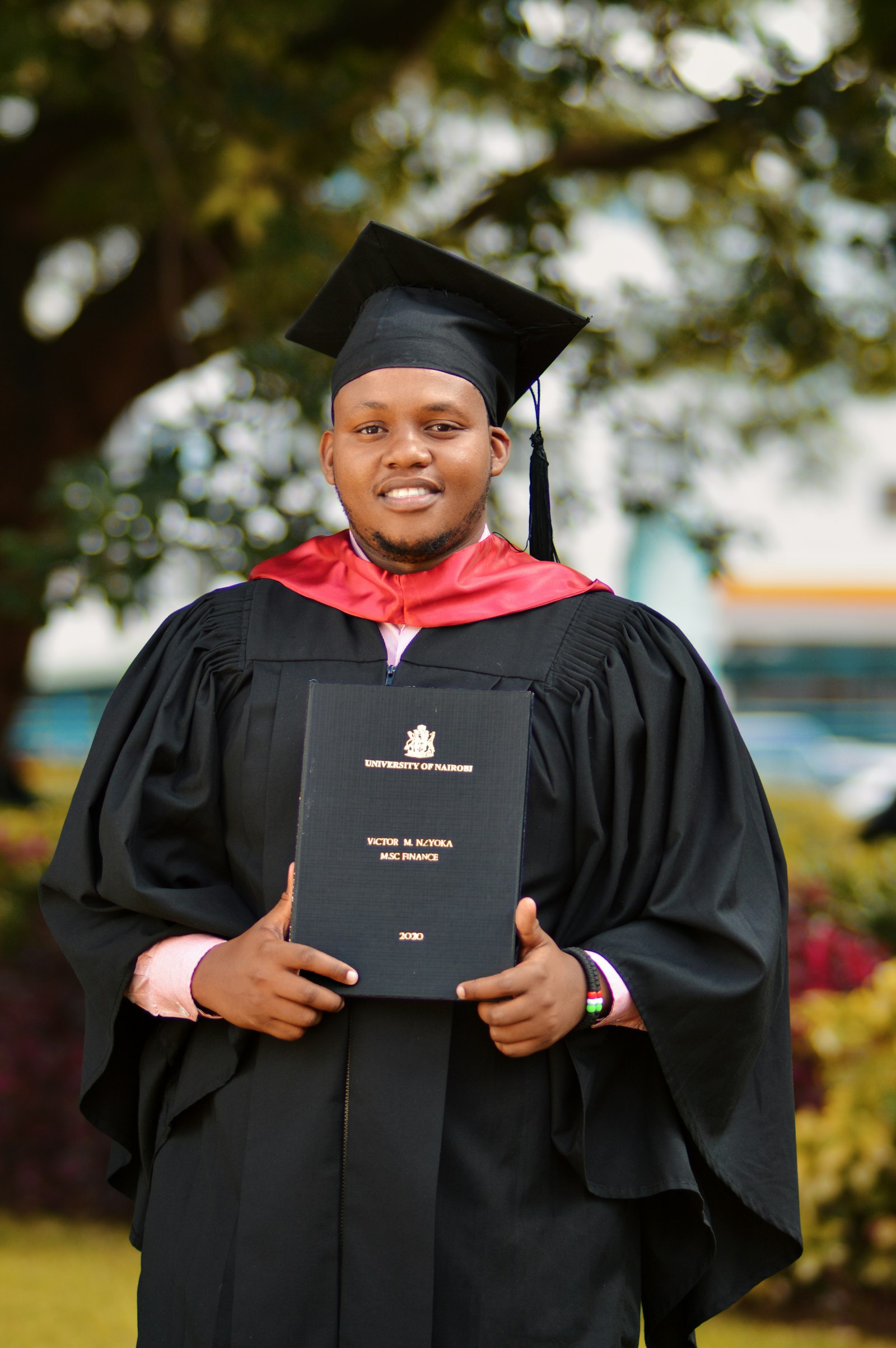 African graduate in cap and gown holding university degree representing JAMB 200 plus achievement