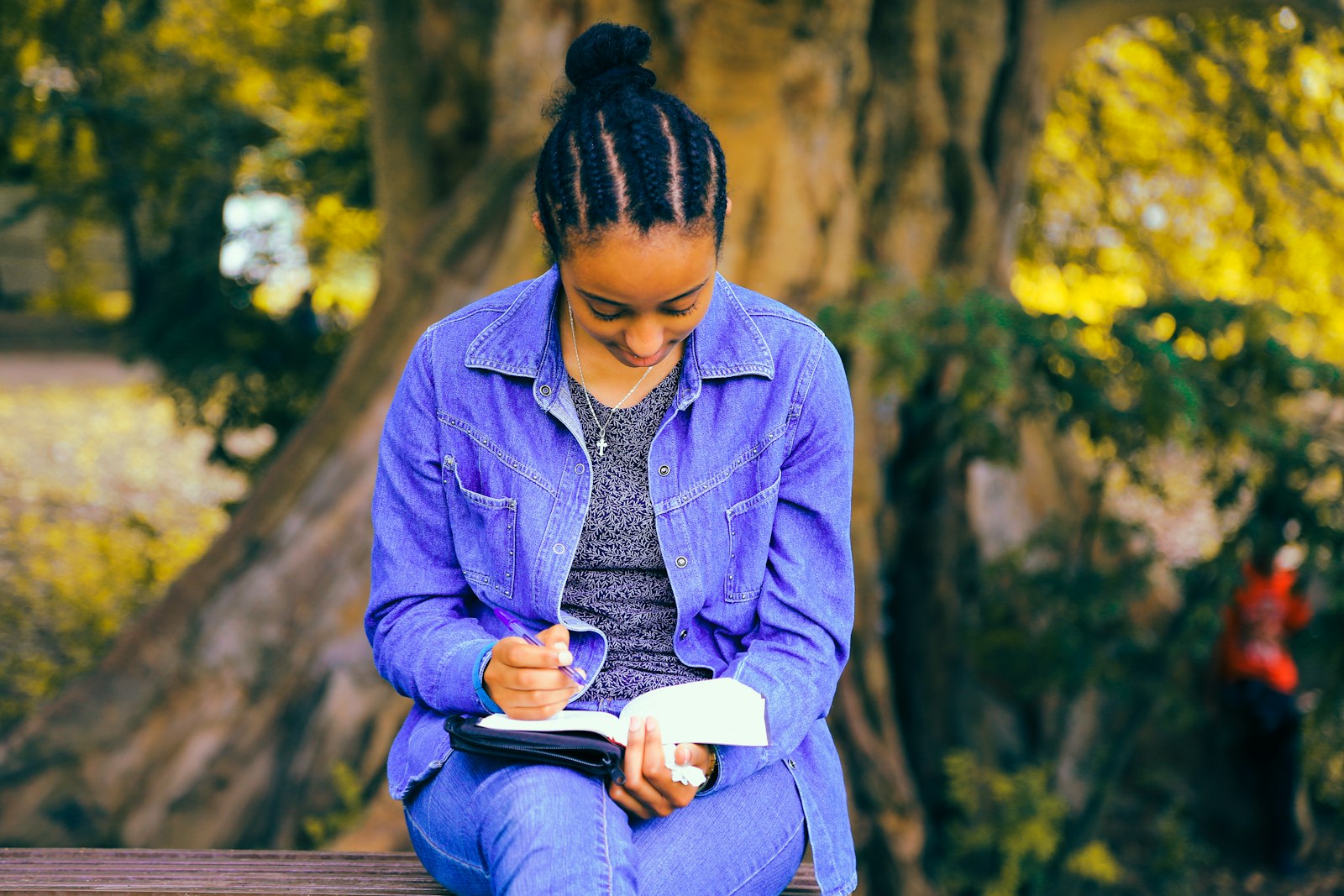 A Nigerian student preparing for Post UTME 2026 by studying with a notebook and pen