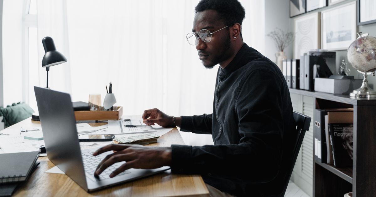 Nigerian graduate learning a paying skill on a laptop during the service year
