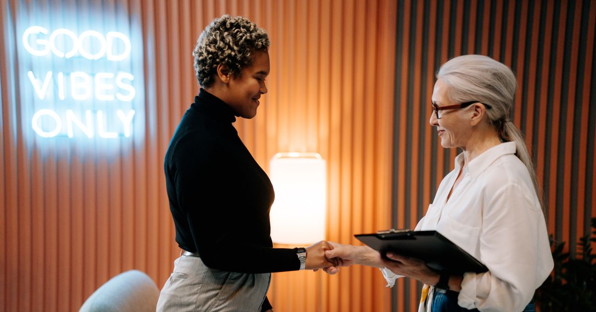 Nigerian graduate shaking hands in a job interview
