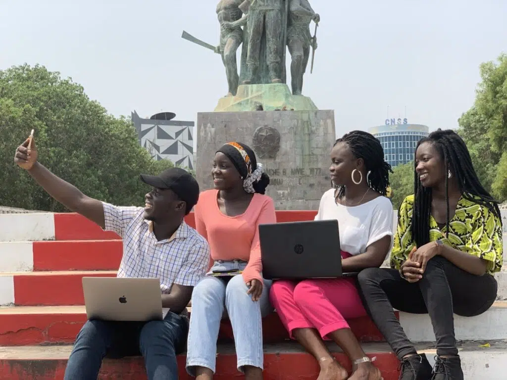 Nigerian students with laptops applying for the NELFUND student loan 2026