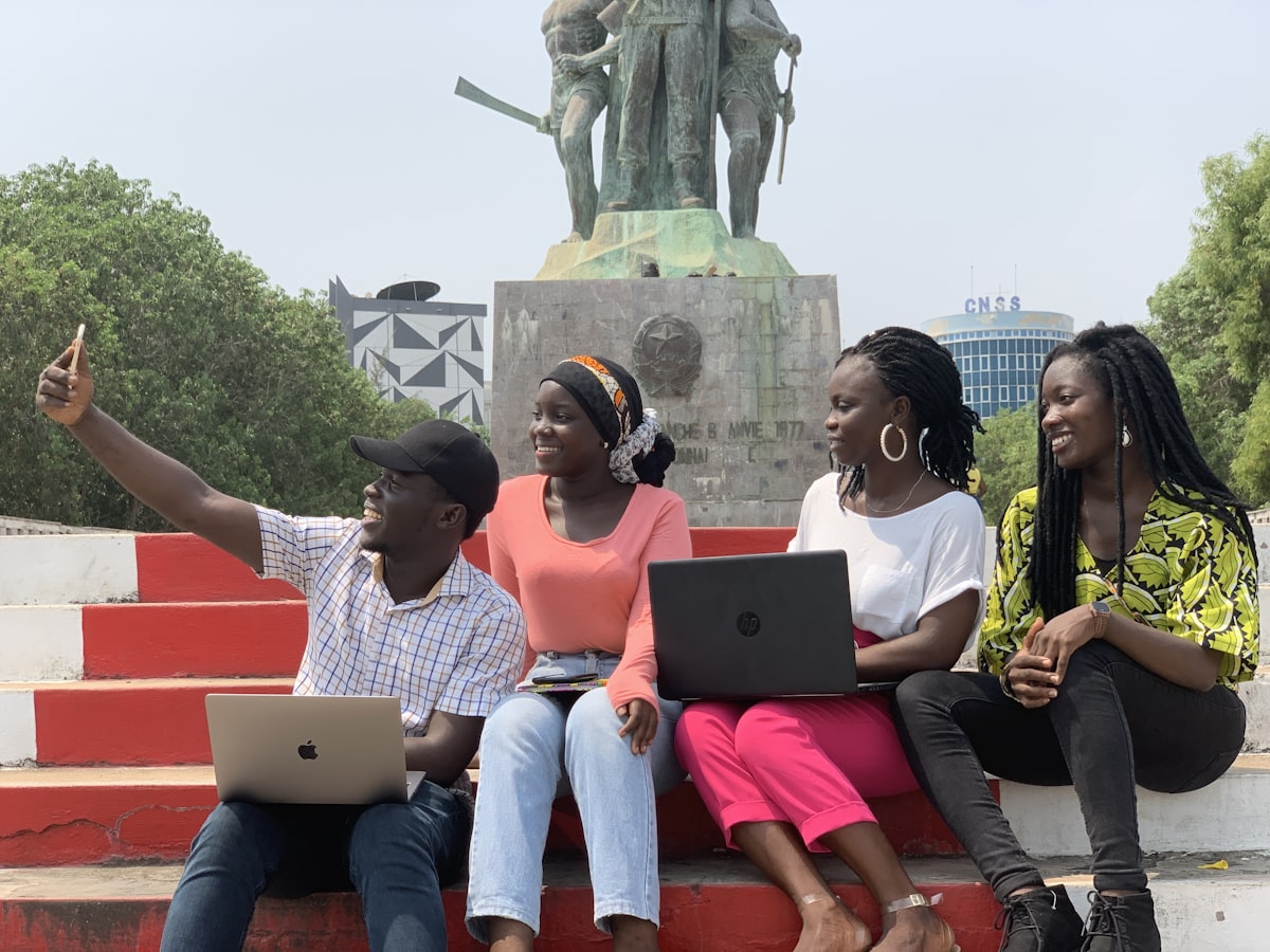 Nigerian students with laptops applying for the NELFUND student loan 2026