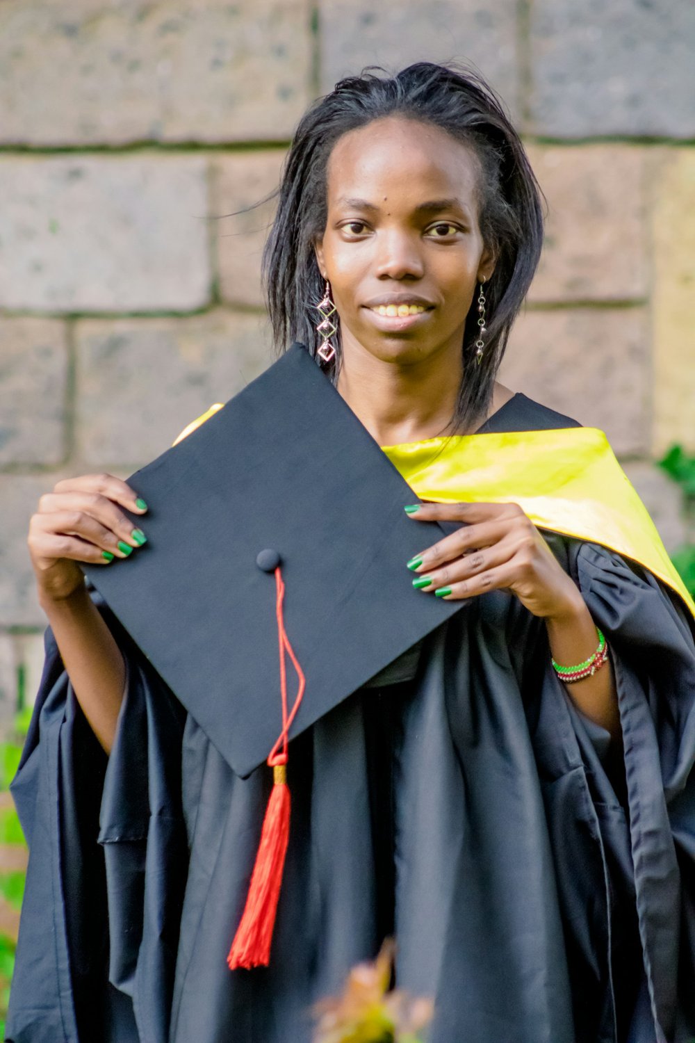 African master's graduate in cap and gown, eligible to apply for the UK Graduate Route