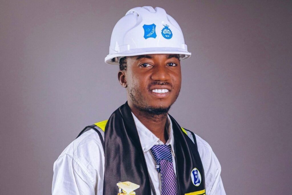 Young Nigerian engineering graduate wearing a hard hat and a Class of 2025 stole