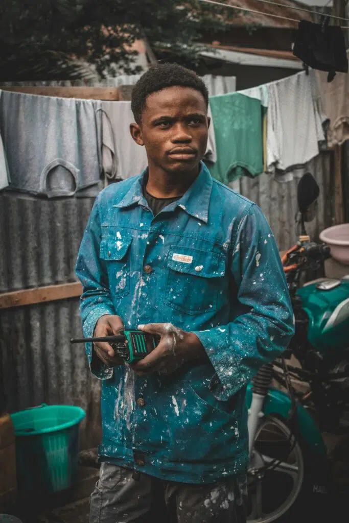 Young Nigerian man in work clothes at a workshop yard during his SIWES industrial training