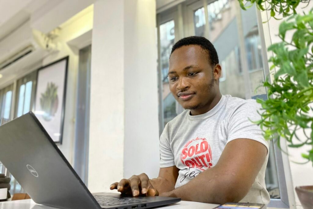 Nigerian university student working on a laptop